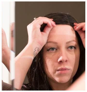 woman applying medical wig