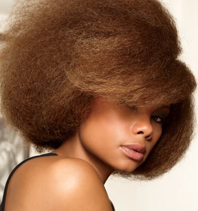 Woman with blown out colored brown natural hair