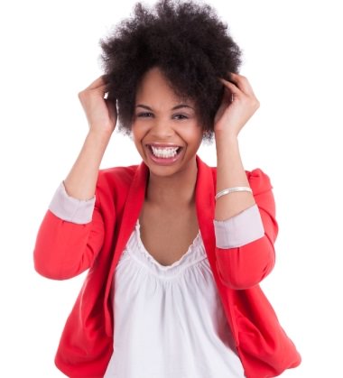 Woman touching her natural hair smiling