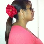 Ponytail accessorized with red flower clip