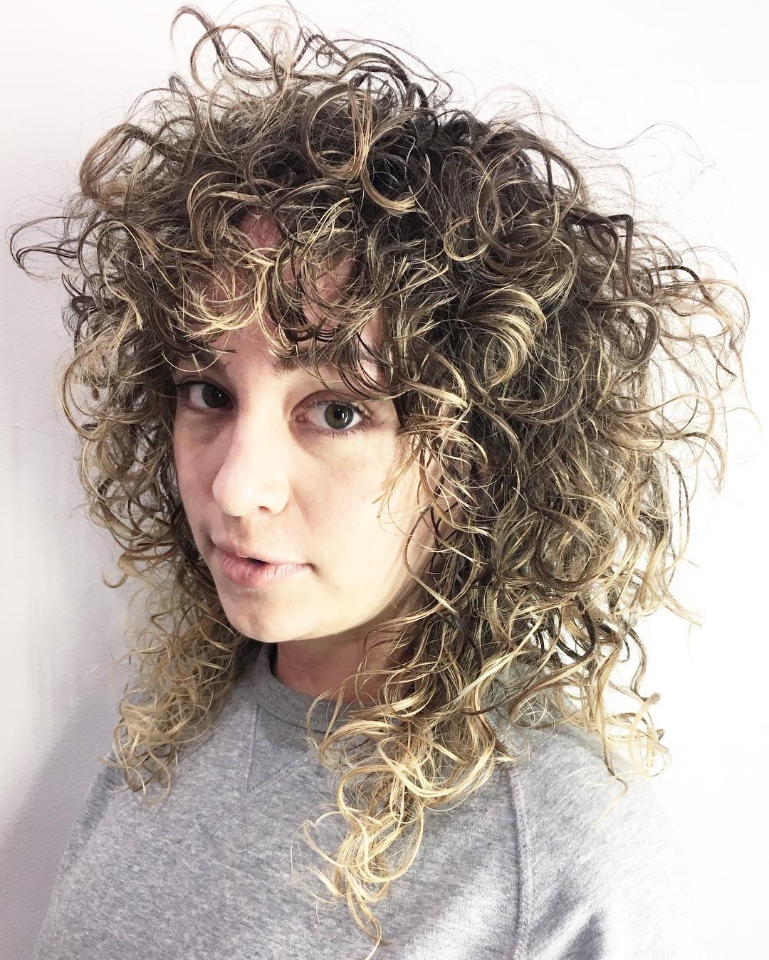 Curly Brown Hairstyle With Highlights
