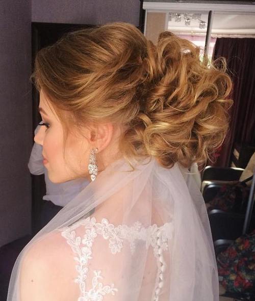 curly voluminous updo for brides