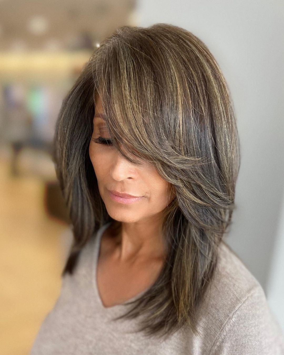 Ash Brown Hair with Highlights and Long Side-Swept Bangs