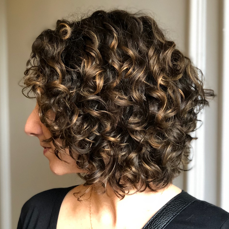 Medium Curly Brown Hairstyle With Highlights