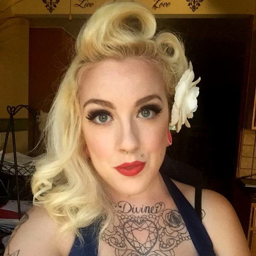 blonde asymmetrical victory rolls hairstyle
