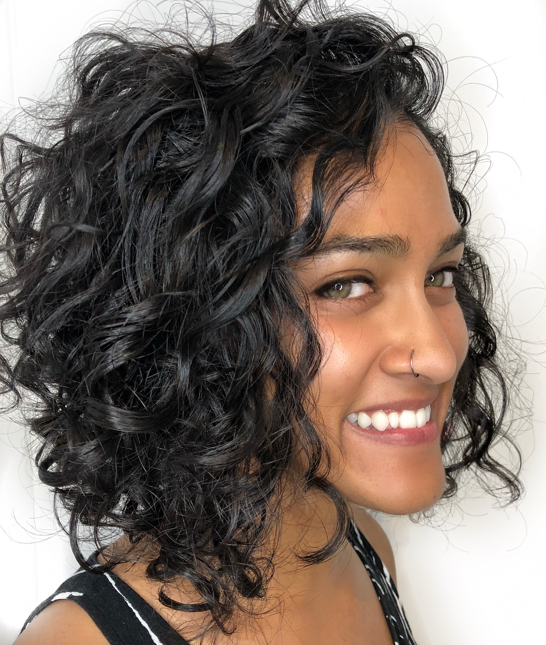 Black Curly Tousled Angled Bob Hairstyle