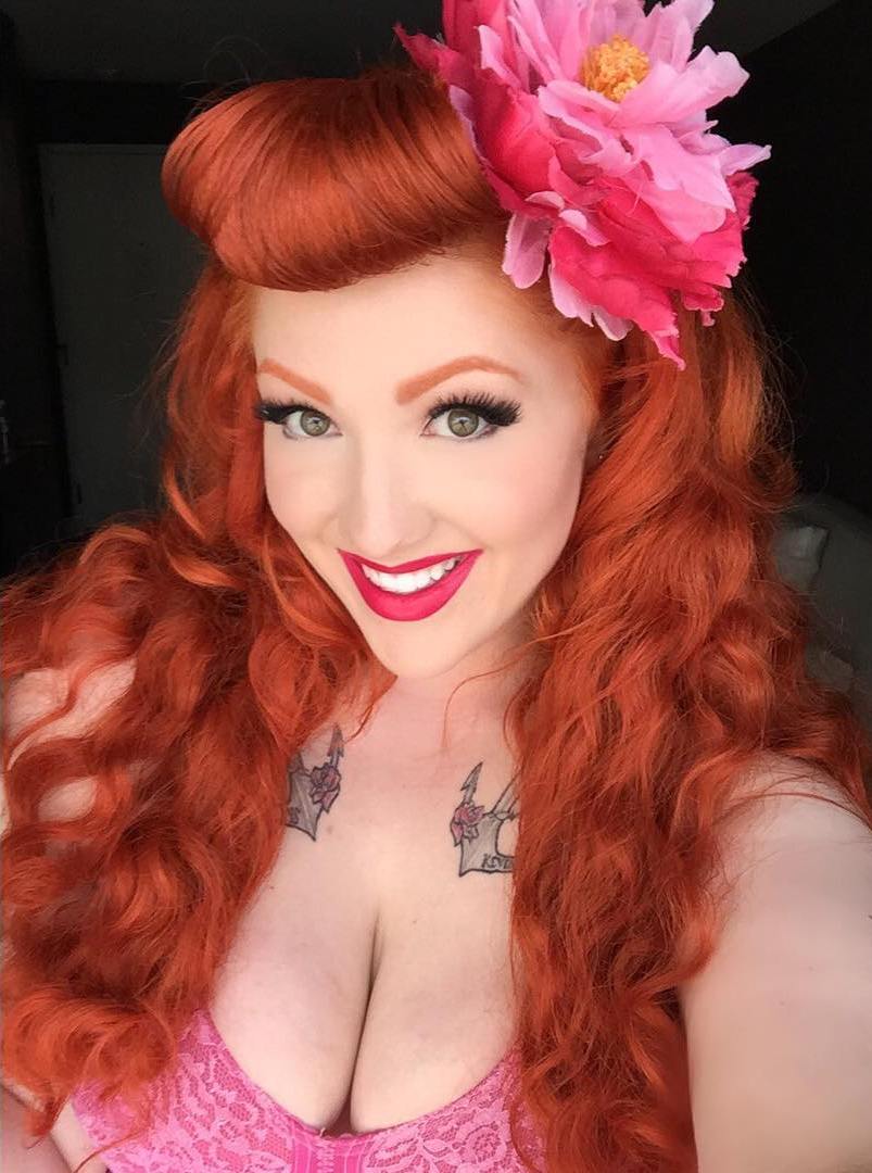 Red Wavy Hairstyle With Pin Up Bangs