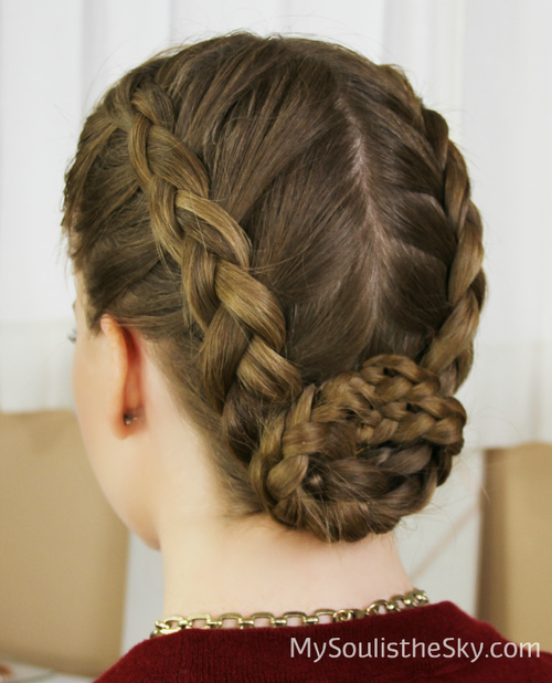 centre-parted braided updo with a bun