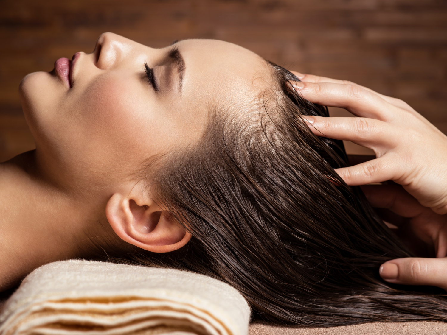 Woman in Spa Enjoying a Scalp Massage