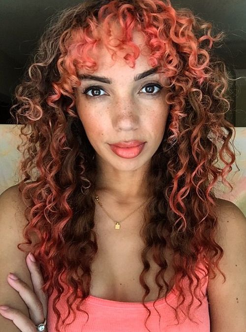 curly brown hair with pastel pink highlights
