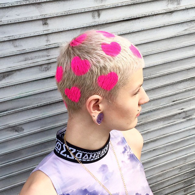Short Blonde Hairstyle With Pink Hearts Tats