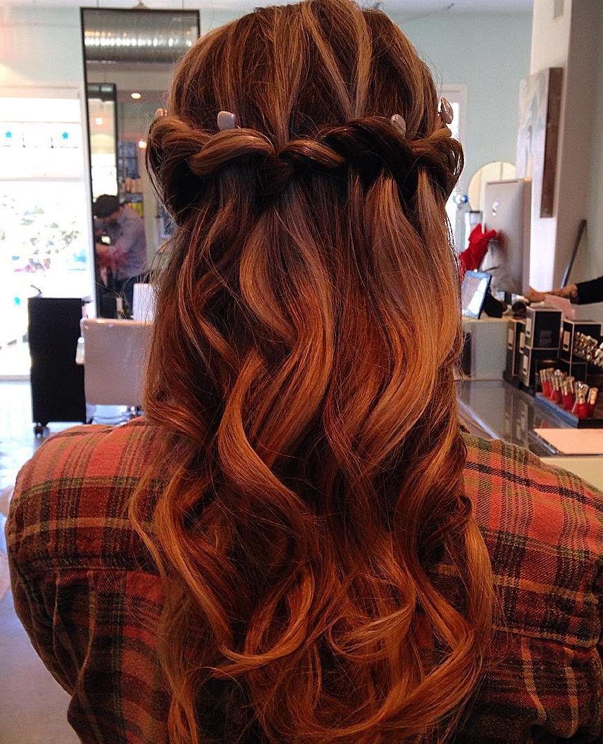red curly half updo with waterfall braid