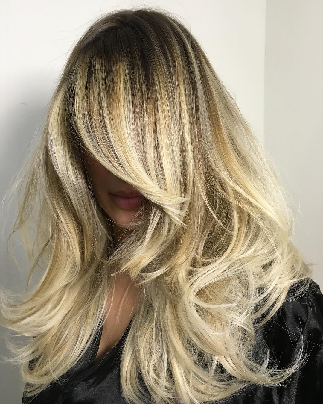 Long Blonde Layered Hairstyle With Roots Fade