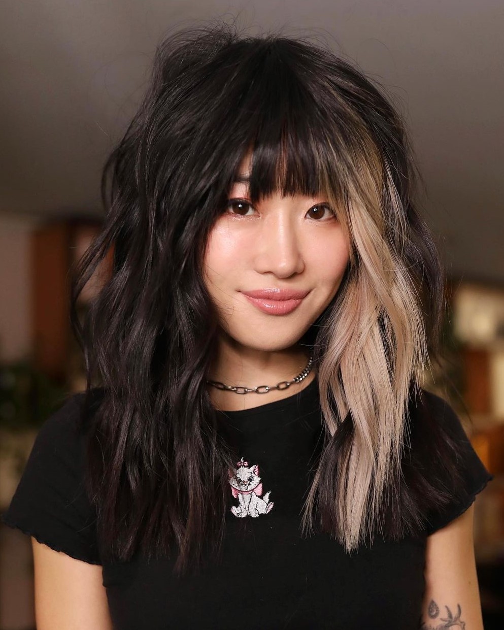 Asian Hairstyle with Bangs and Chunky Blonde Streak