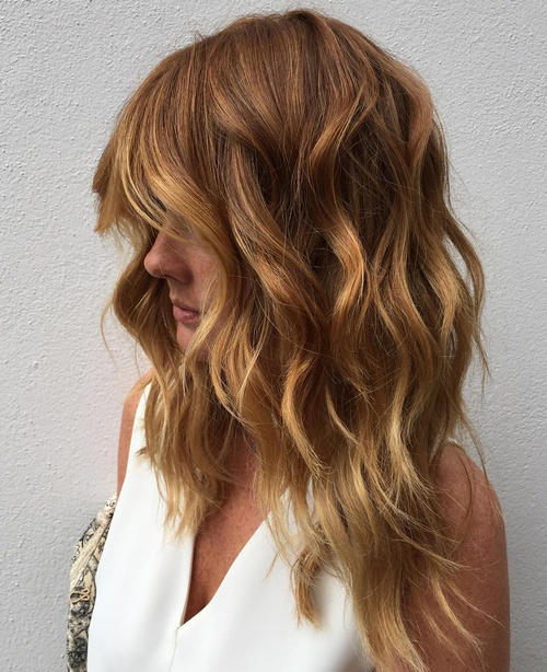 caramel layered hair with golden blonde highlights