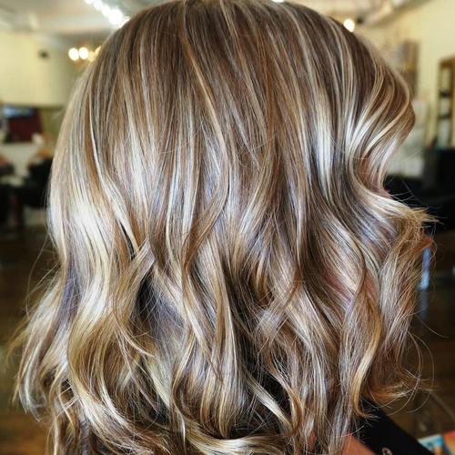 medium brown hairstyle with caramel and blonde highlights