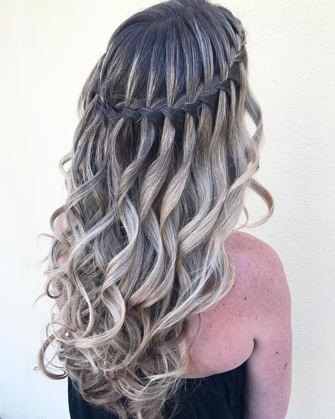Curly Hairstyle With Waterfall Braid