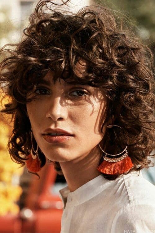 messy curly bob with bangs