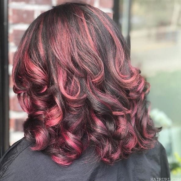 pink highlights in curly brown hair