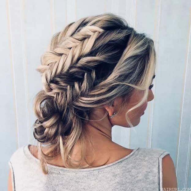 braided low bun with curly frizzy hair
