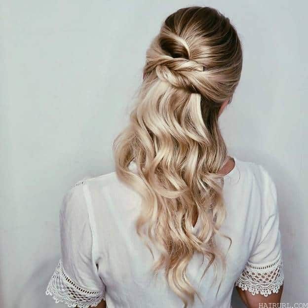knotted half-up style with curly frizzy hair