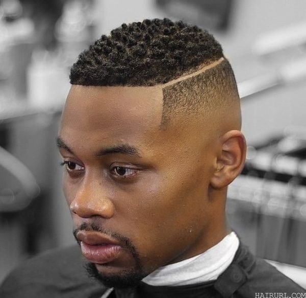 black boy's fade haircut with hard part