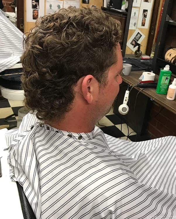 guy with curly mullet hair