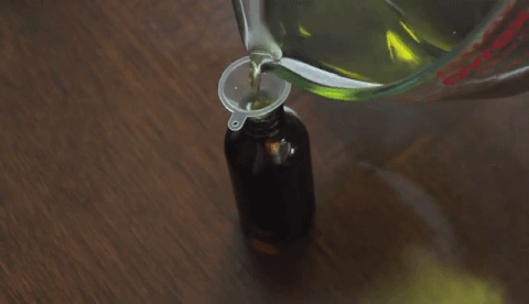 pouring oil into bottle
