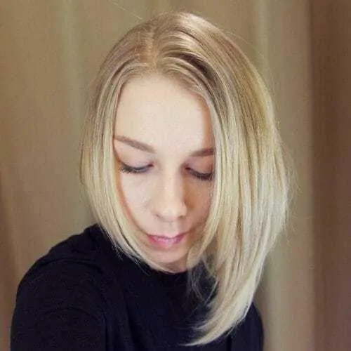 Woman with a blonde asymmetrical bob, one of the different types of bobs. 