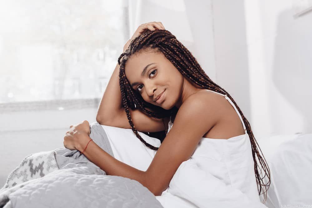Black girl with braids preparing for bed after a night shower.