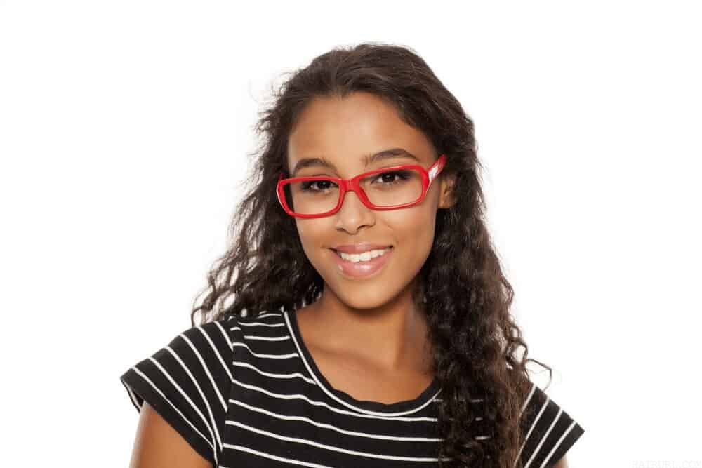 Beautiful young African American female with human hair extensions attached to her own hair