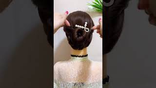 Rope Braided Low Bun Hairstyle With Hair Accessory